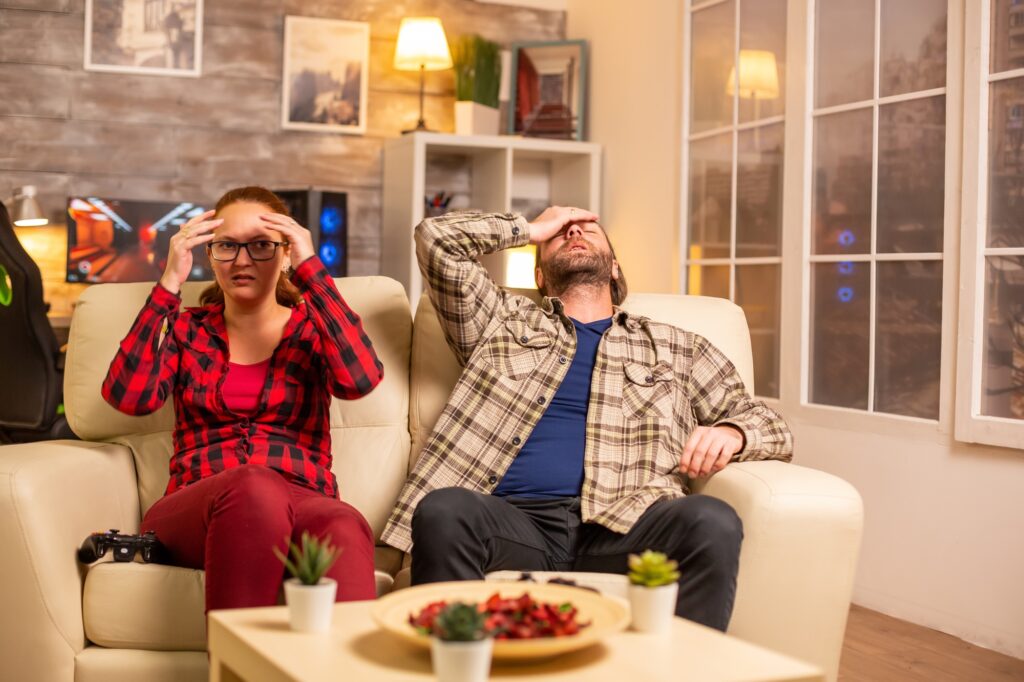 Angry and frustrated gamers losing while playing video games